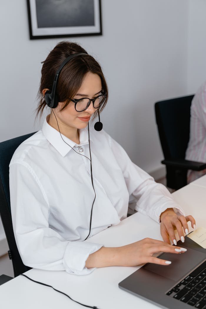 The Art of Drawing Readers In: Your attractive post title goes here Cheerful woman in a call center using a laptop and headset for customer support.